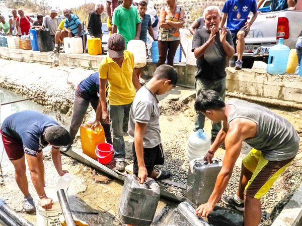 Venezolanos se abastecen de velas y tanques de agua por los apagones
