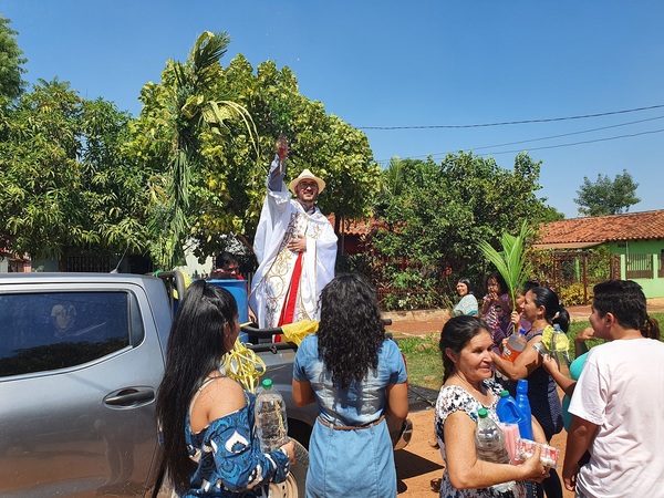 Plausible gesto: Sacerdote salesiano bendice palmas casa por casa