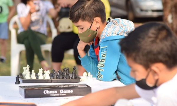 Chicos practican ajedrez al aire libre en Santa Rita