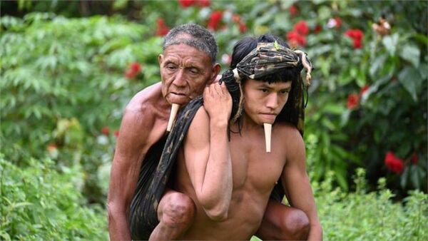 Covid: la potente imagen del joven indígena de una tribu aislada que cargó a su padre durante 6 horas para que lo vacunaran