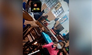 Susto por foto de estudiante que apunta con rifle a su compañera