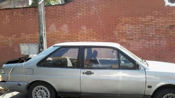 Auto abandonado rodeado de malezas