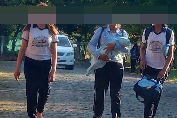 Adolescente estudia con su pequeño hijo